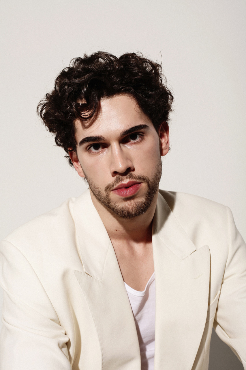 Alexandre Sellani in a cream blazer, close portrait