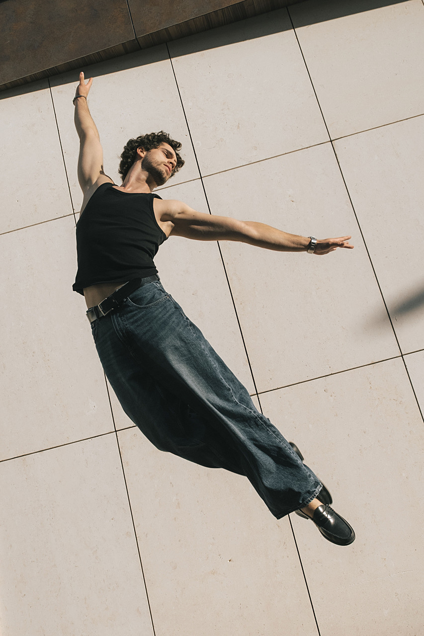 Alexandre Sellani leaping mid-air over a tiled plaza floor