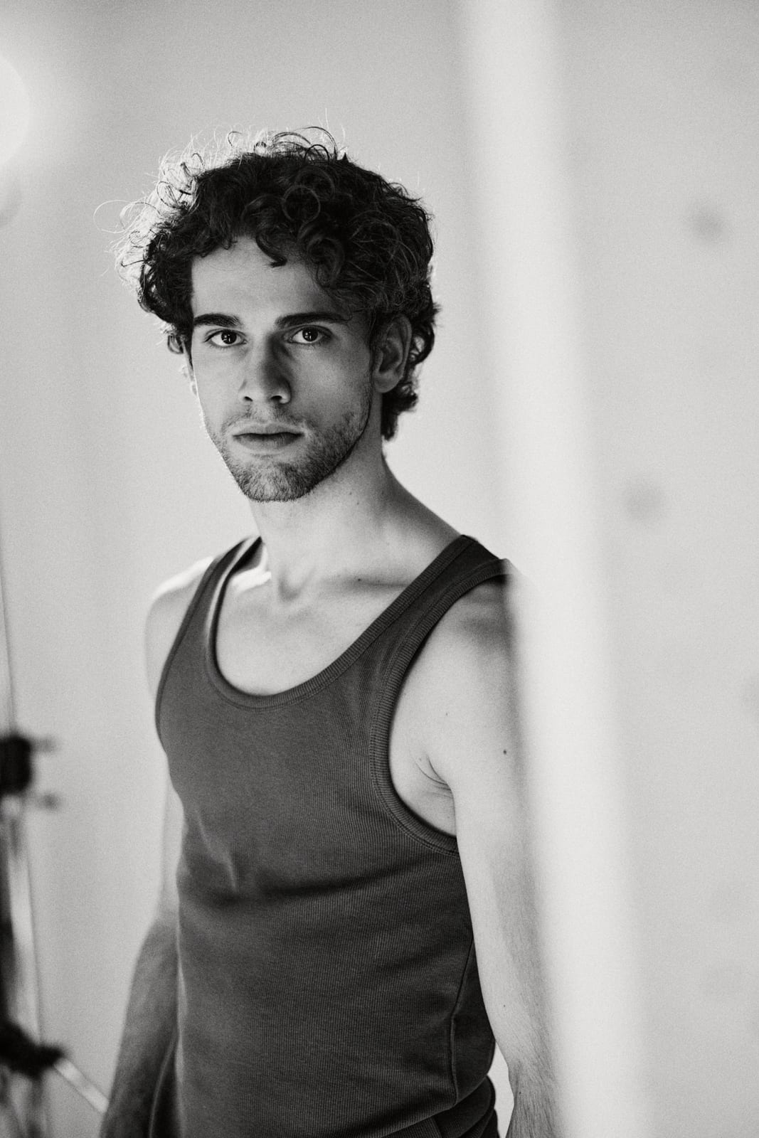 Alexandre Sellani in a tank top, black-and-white portrait in natural window light